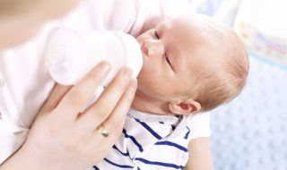 Mother is feeding newborn baby. Infant nutrition