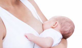 mother and newborn baby  lactation on white background